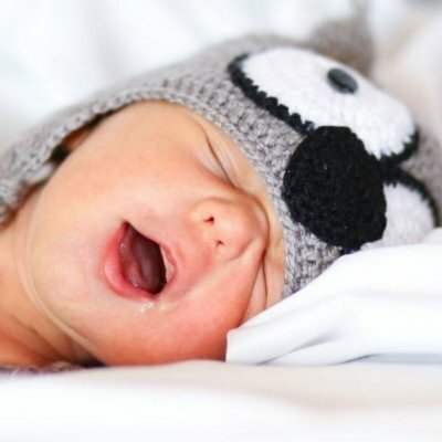 baby yawning wearing hat